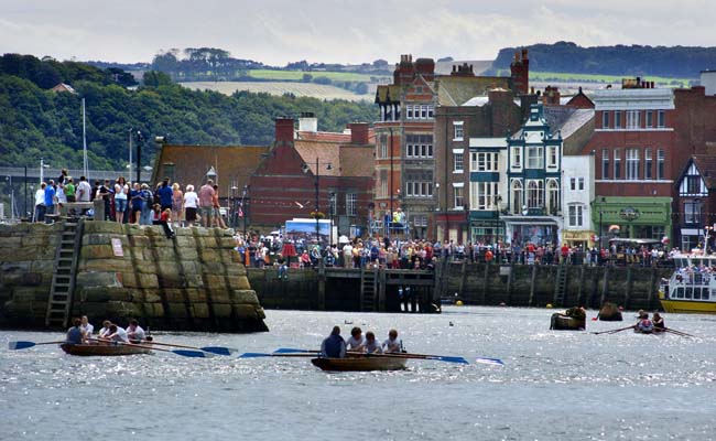 One of the rowing races at the Regatta – crowds line the harbour as the boats race to the finish – © Ceri Oakes/Whitby Gazette